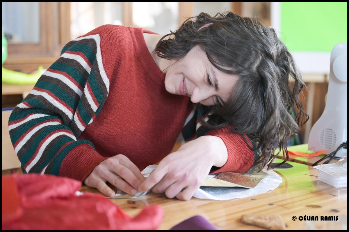 Participante à table qui travaille sur son ouvrage